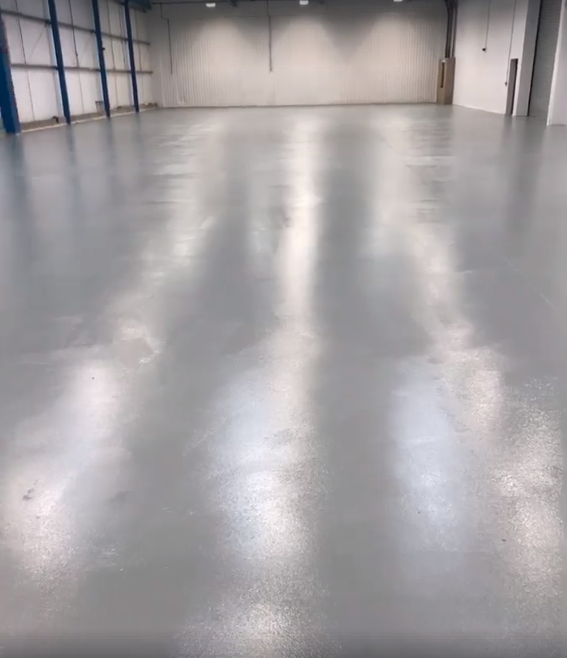 Factory floor coating for a robotic manufacturing cell